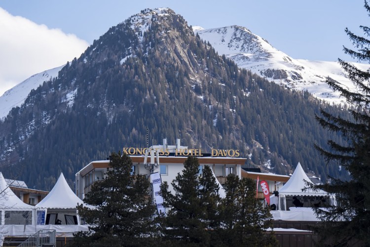 View of Kongress Hotel Davos with snow-capped mountains in the background.